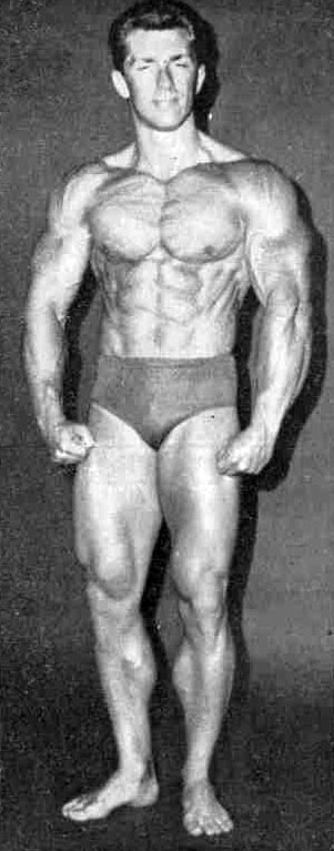 Bob Gajda flexing his chest, abs, arms, and legs for the camera