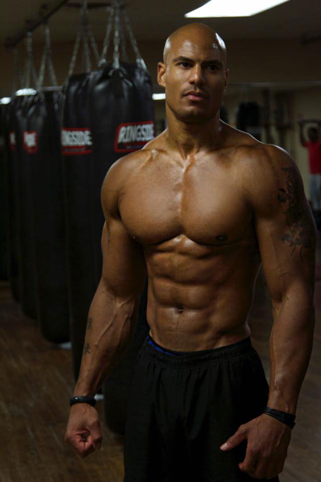 Brandon Carter showing off his abs in the gym.