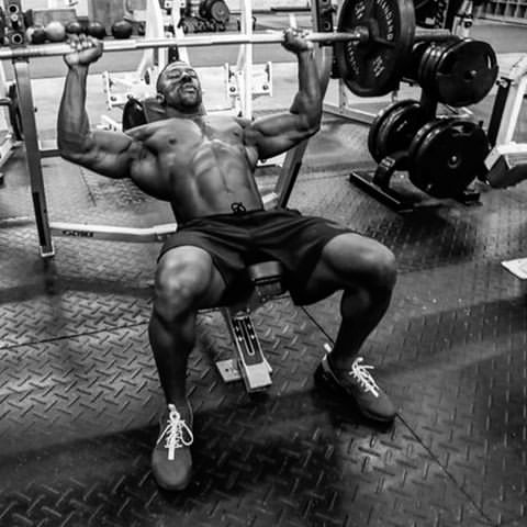 Coty Hart doing heavy bench press shirtless