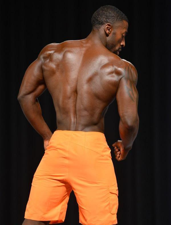 Coty Hart showing his ripped back on the Men's Physique stage