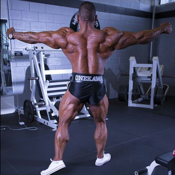 Darryn Onekawa flexing his back and arms for the camera