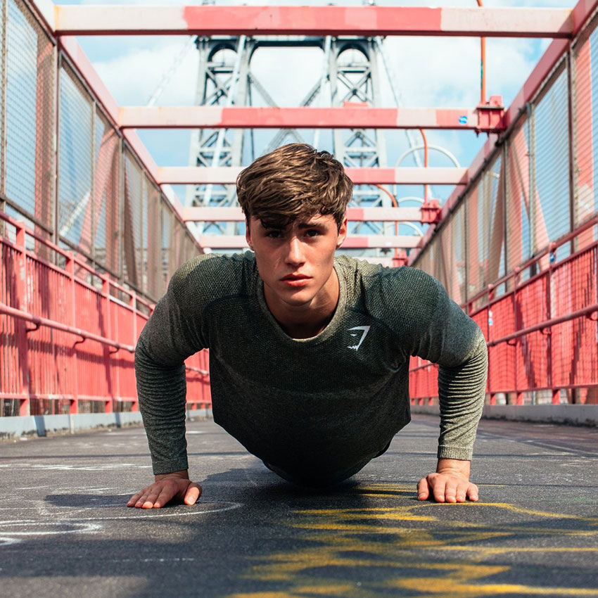 David Laid performing push ups in a photo shoot. 