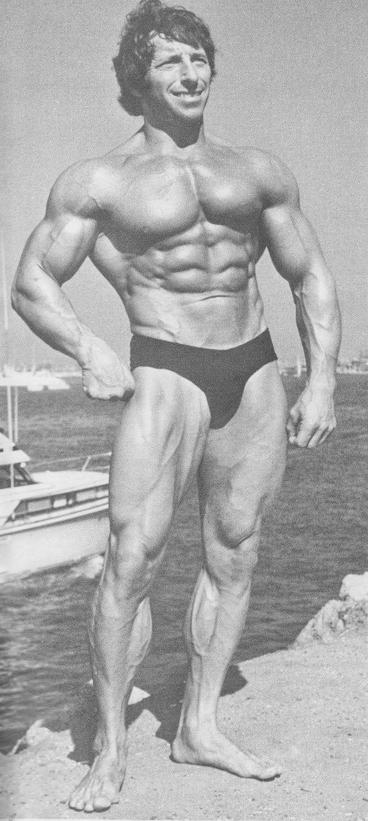 Eddie Giuliani posing for a photo showing off his muscular physique