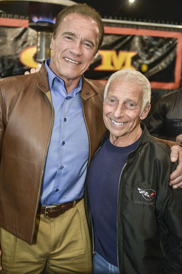 Eddie Giuliani taking a photo with Arnold Schwarzenegger