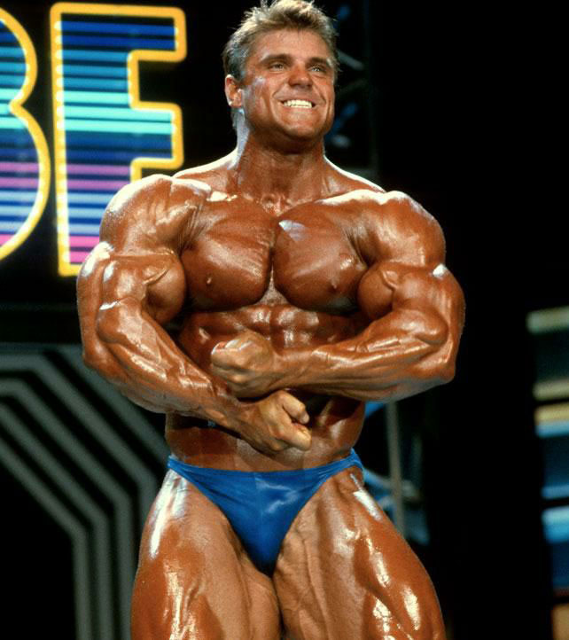 Eddie Robinson flexing his muscles on stage,