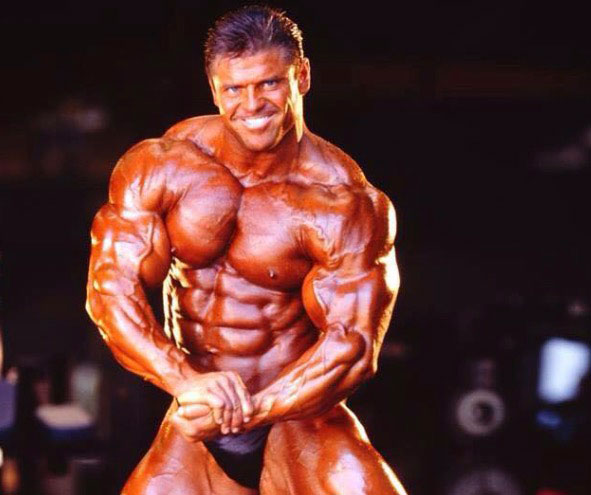 Eddie Robinson flexing his huge biceps.