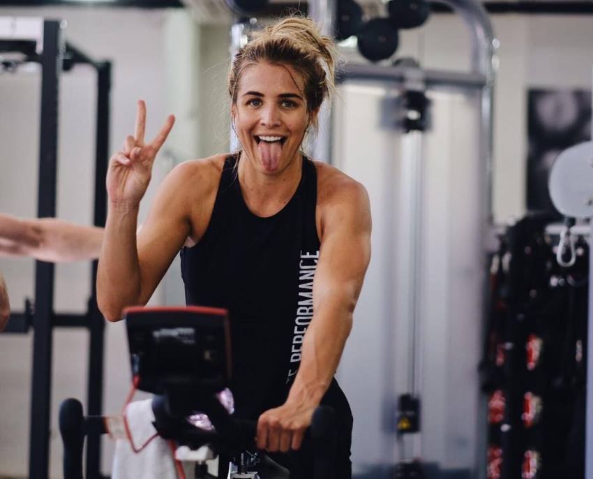 Gemma Atkinson showing peace sign and smiling with a tongue out