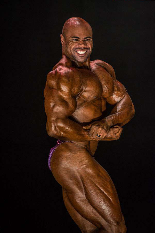 Gerald Williams posing on stage at a competition.