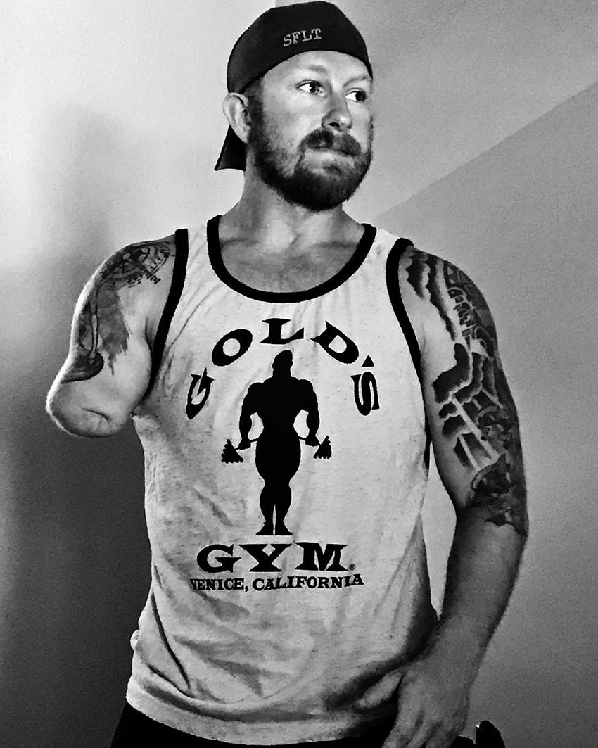 Jared Bullock wearing a Gold's Gym vest in a photo shoot.