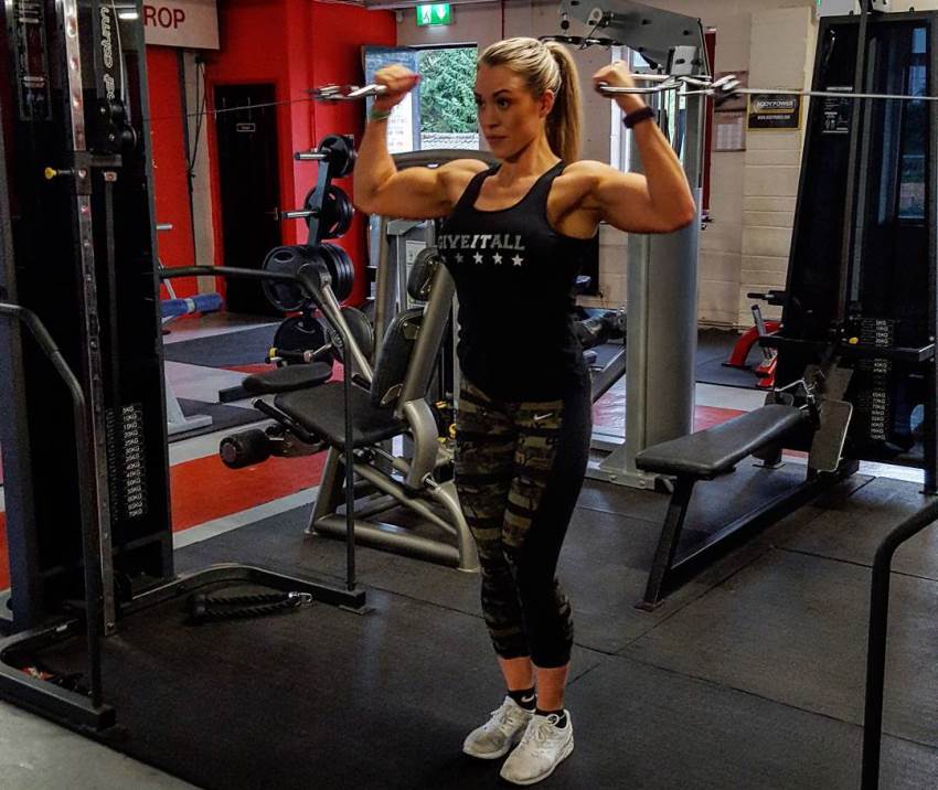 Jess Clutterbuck doing cable biceps curls in the gym