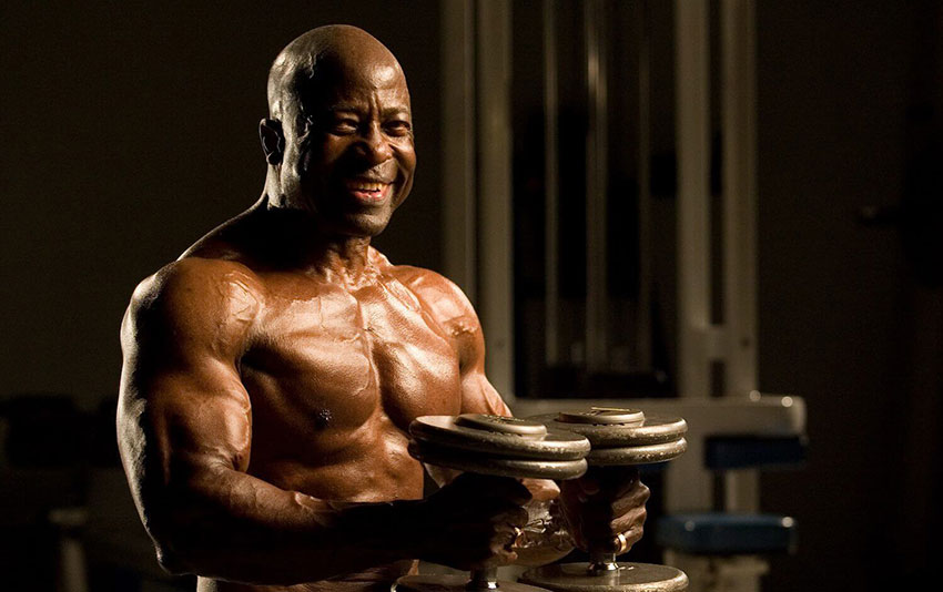 Jim Morris holding dumbbells in a photo shoot later in his career.