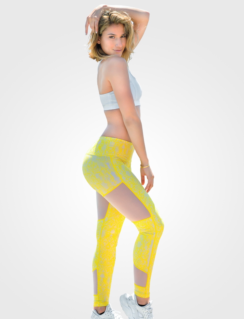 Lexy Panterra posing for a photo in yellow leggings