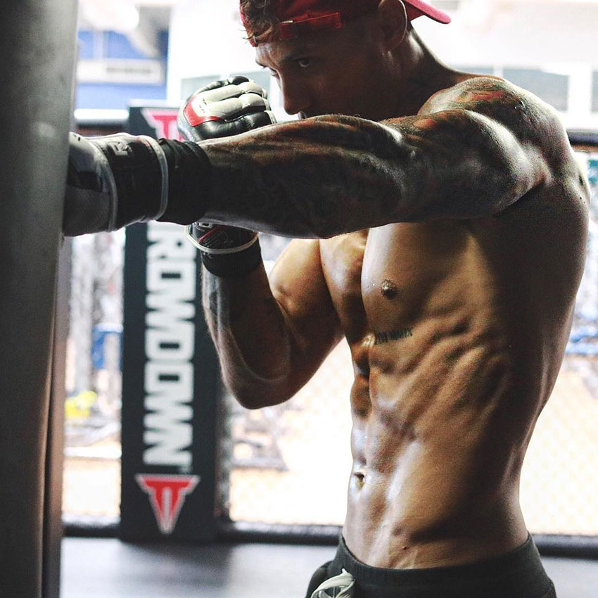 Michael Vazquez punching a punch bag in the gym.