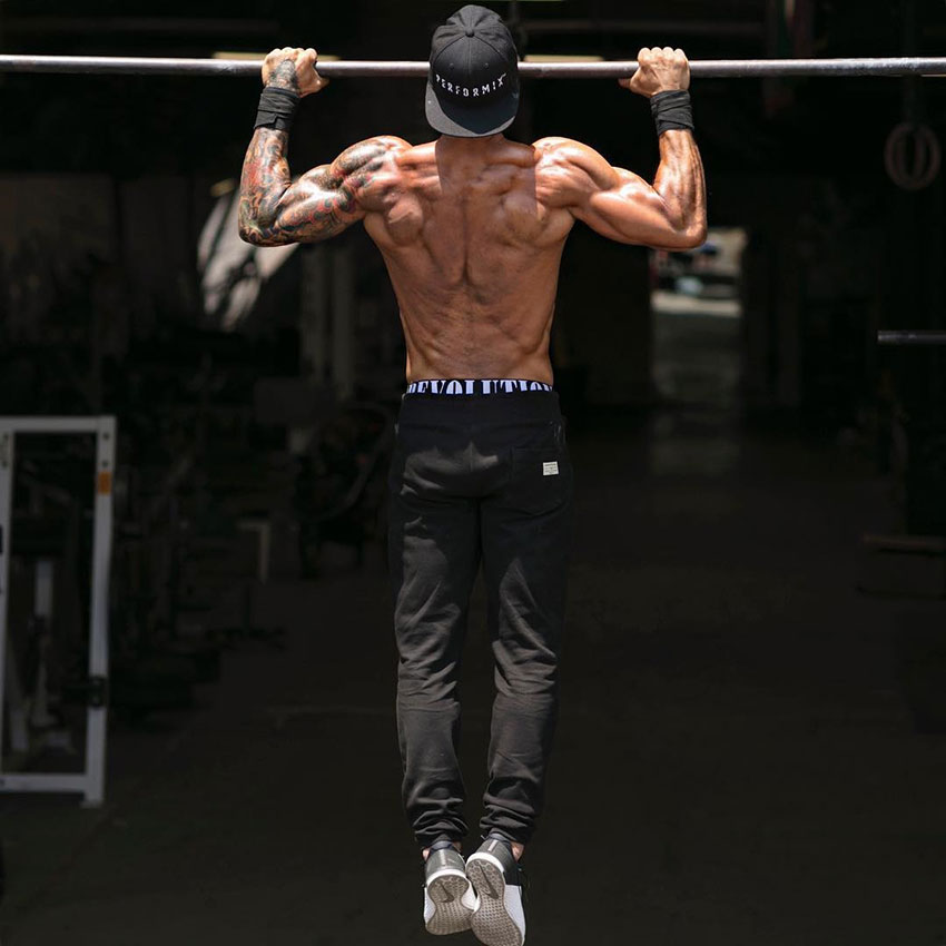 Michael Vazquez performing a pull up showing off his back muscles.