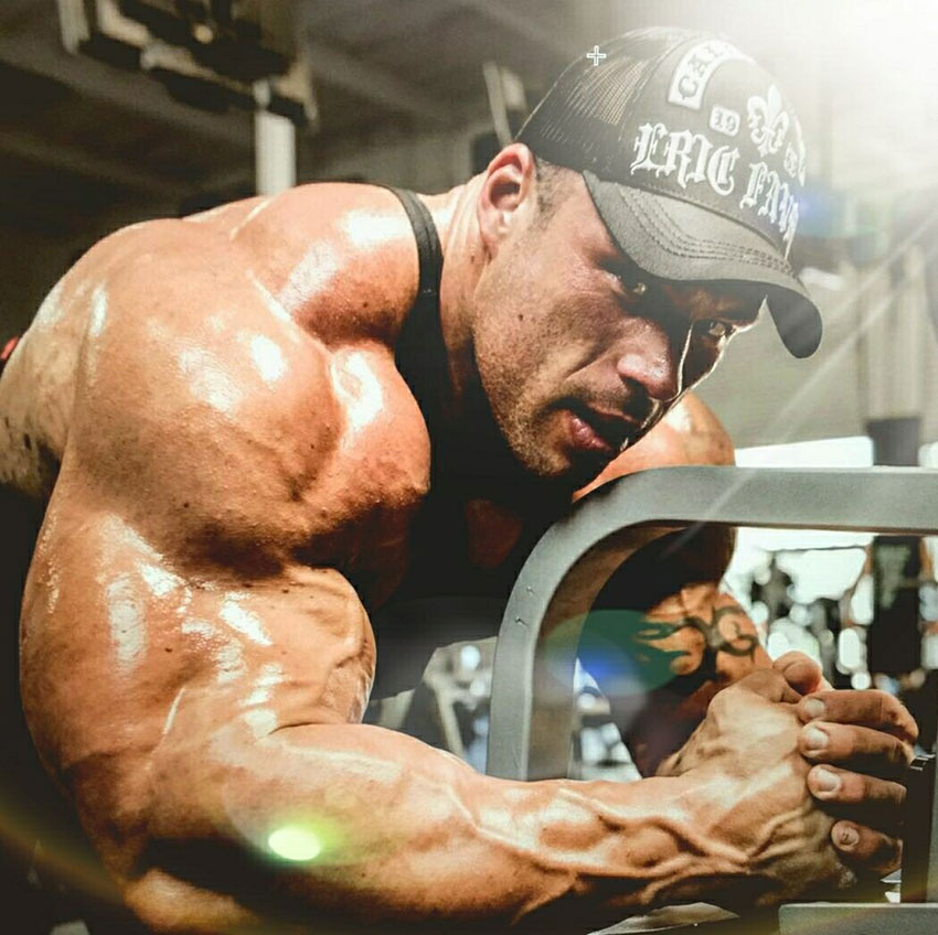 Morgan Aste showing off his large arms in the gym