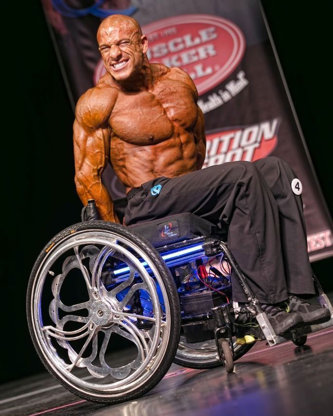 Nick Scott on stage at a bodybuilding competition.