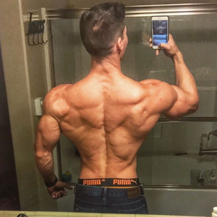 Nimai Delgado taking a selfie of his ripped back