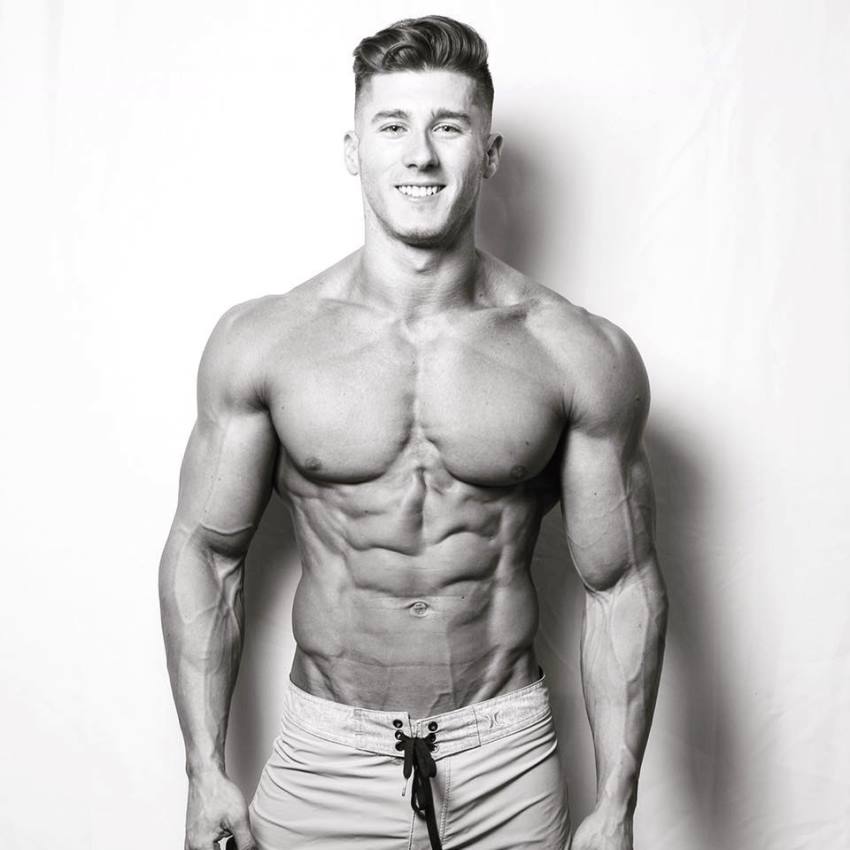 Nimai Delgado posing shirtless for a photo looking ripped