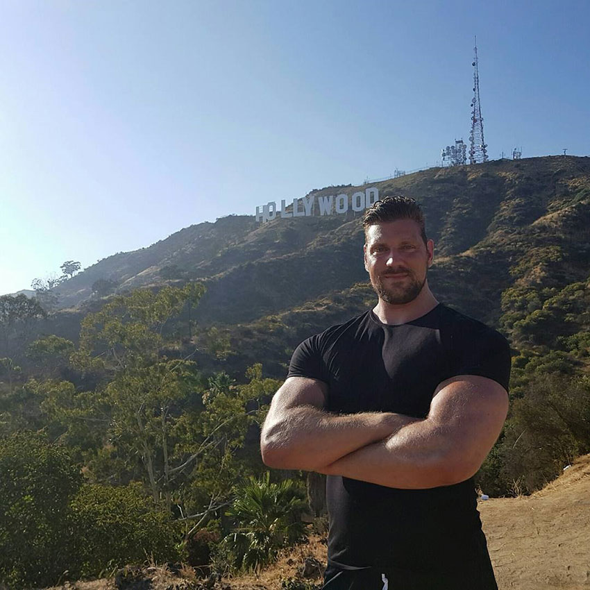 Olivier Richters standing in front of the Hollywood sign.