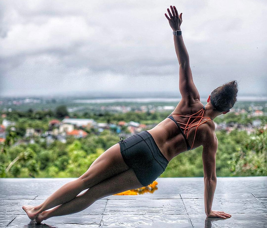 Sarah Bowmar performing yoga outdoors.