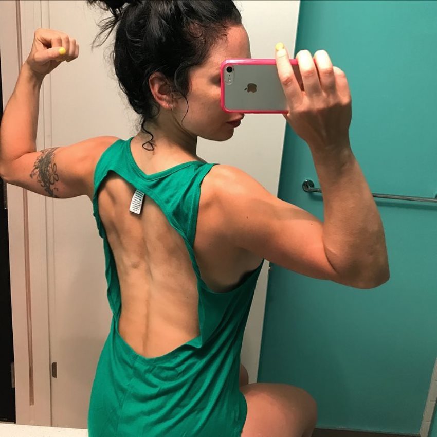 Sarah Van Dusen taking a selfie of her back and arms