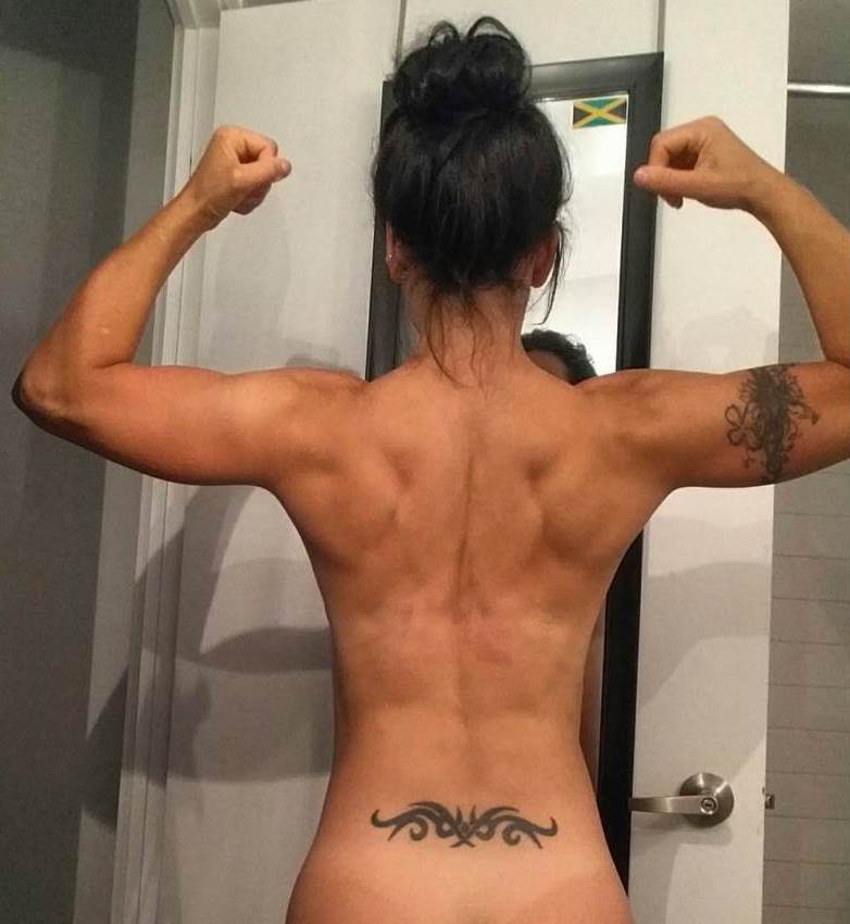 Sarah Van Dusen doing a back double biceps flex for a photo