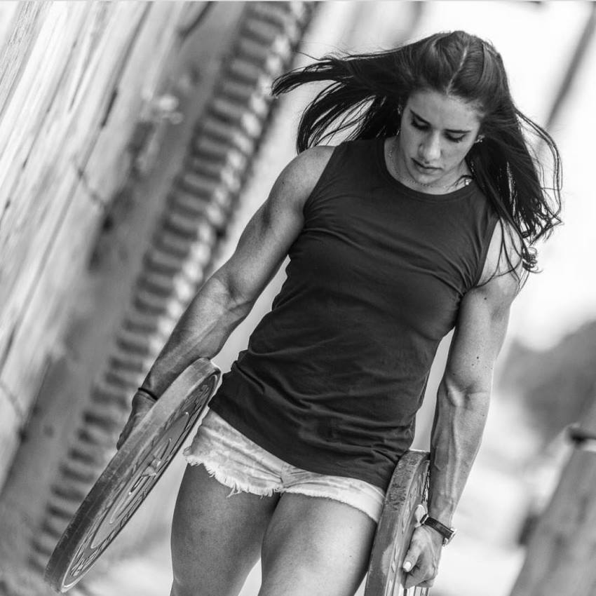 Stefanie Cohen carrying two 20-pound weight plates whilst walking