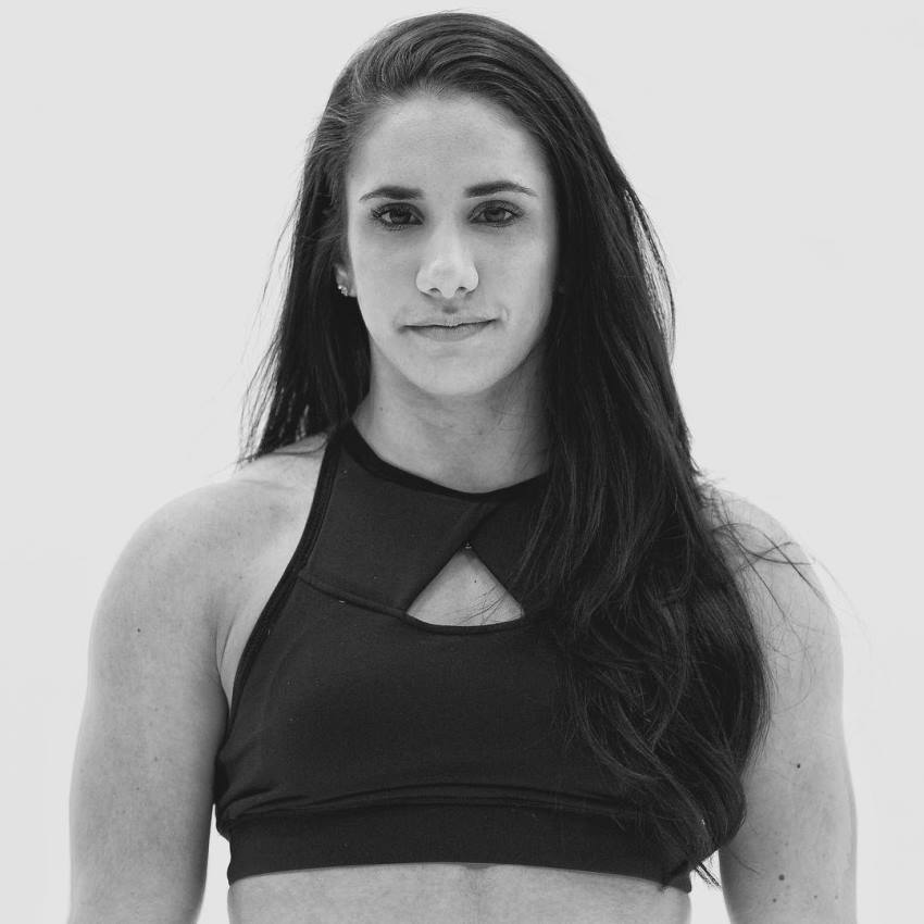 Stefanie Cohen looking at the camera wearing sportsbra