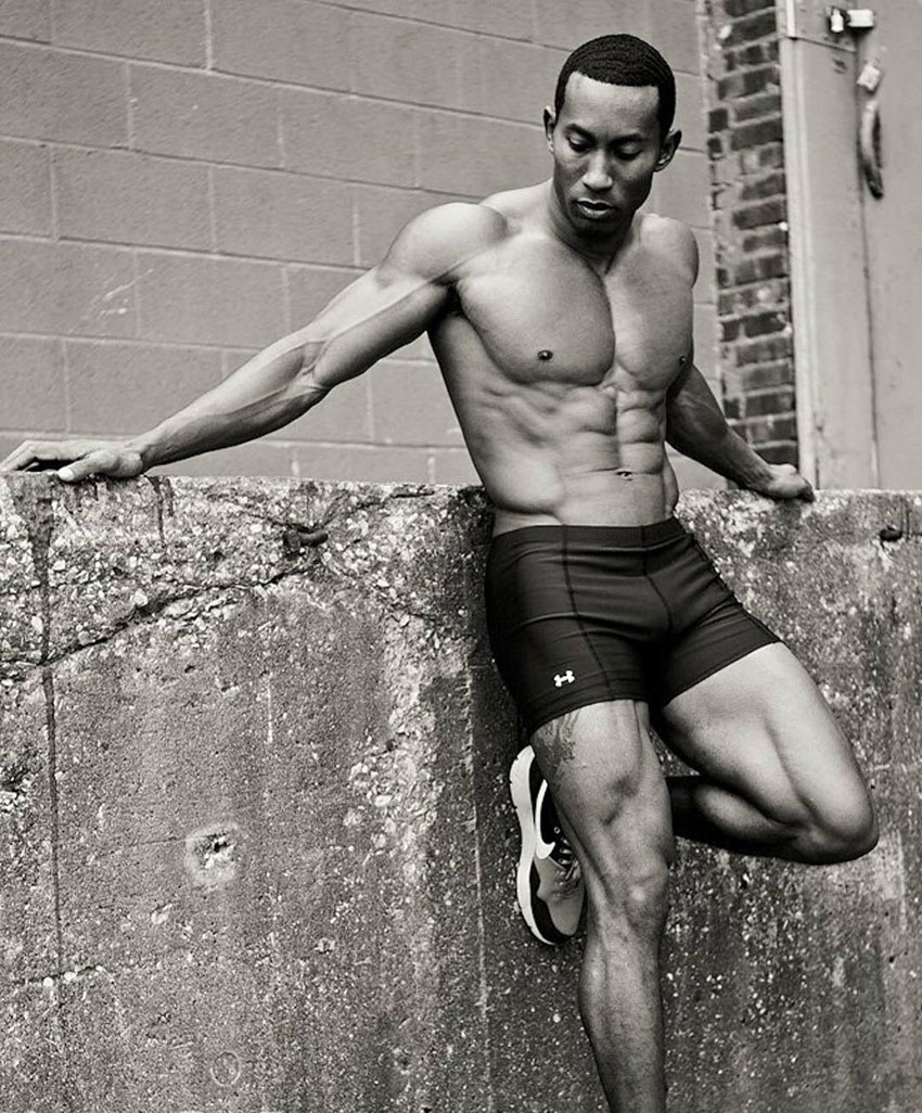 AJ Ellison posing leaning on a wall.
