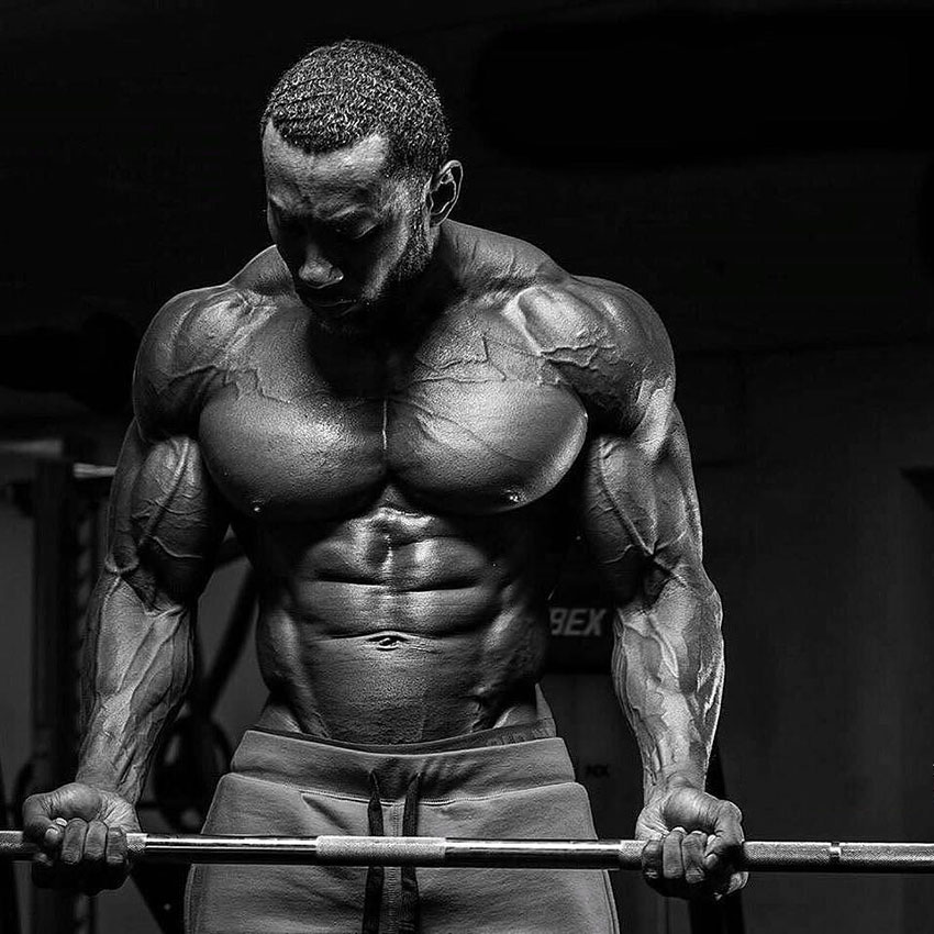 AJ Ellison performing barbell bicep curls.