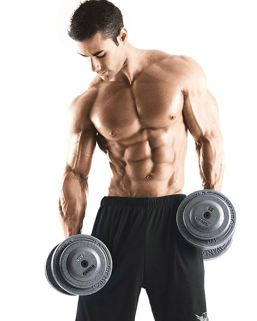 Alex Carneiro holding dumbbells in a photo shoot.