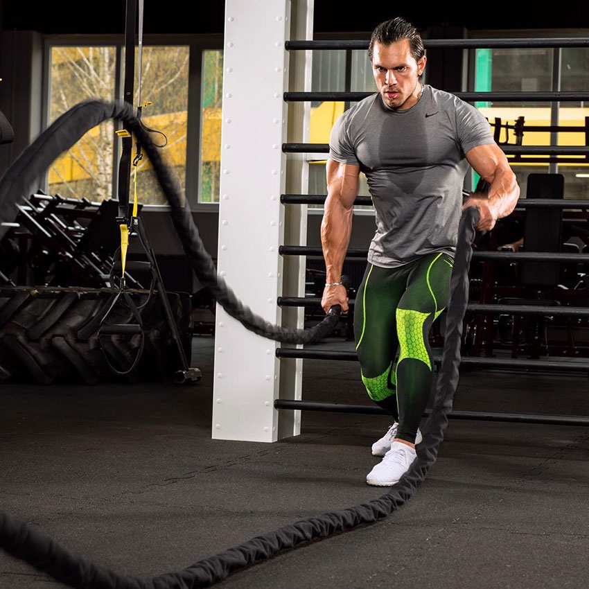 Alon Gabbay using battle ropes in the gym.