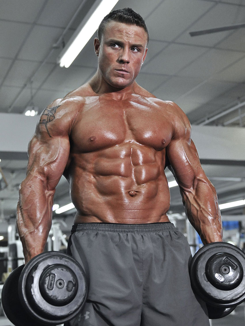 Brad Rowe holding dumbbells in a photo shoot.