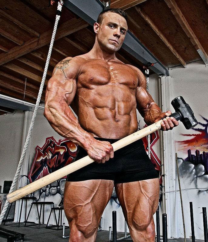 Brad Rowe holding a hammer in the gym.