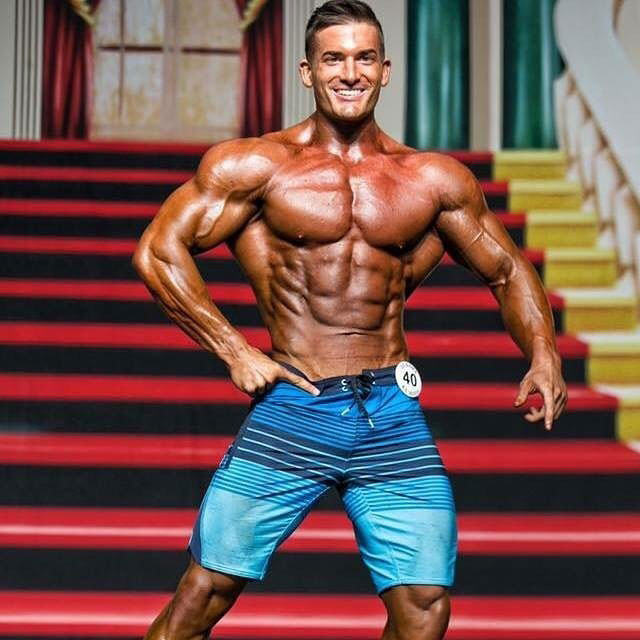 Chase Savoie posing on the bodybuilding stage.