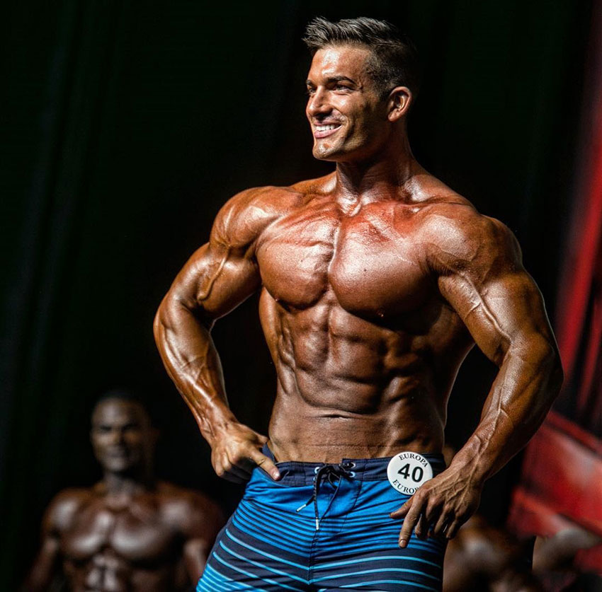 Chase Savoie posing on the bodybuilding stage.