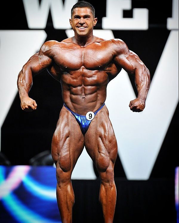 Derek Lunsford posing on the bodybuilding stage.