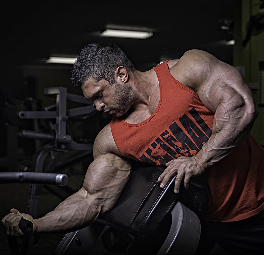 Derek Lunsford performing one arm concentration curls.