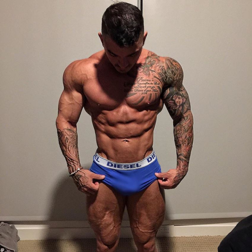Devin Physique posing shirtless unveiling his ripped physique for the photo