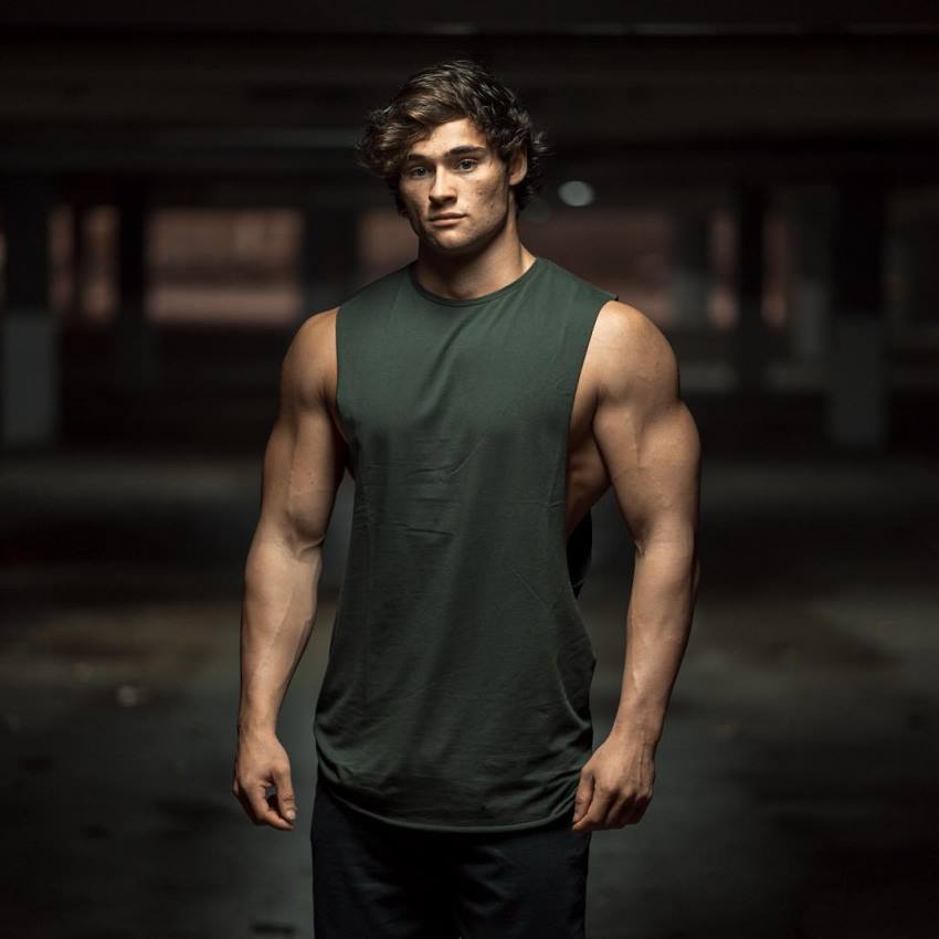 Dylan McKenna posing for the camera, wearing dark green tank top