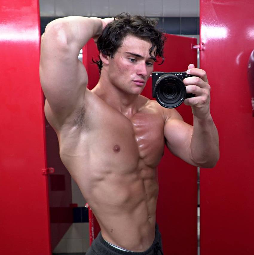 Dylan McKenna taking a shirtless selfie, looking muscular and lean