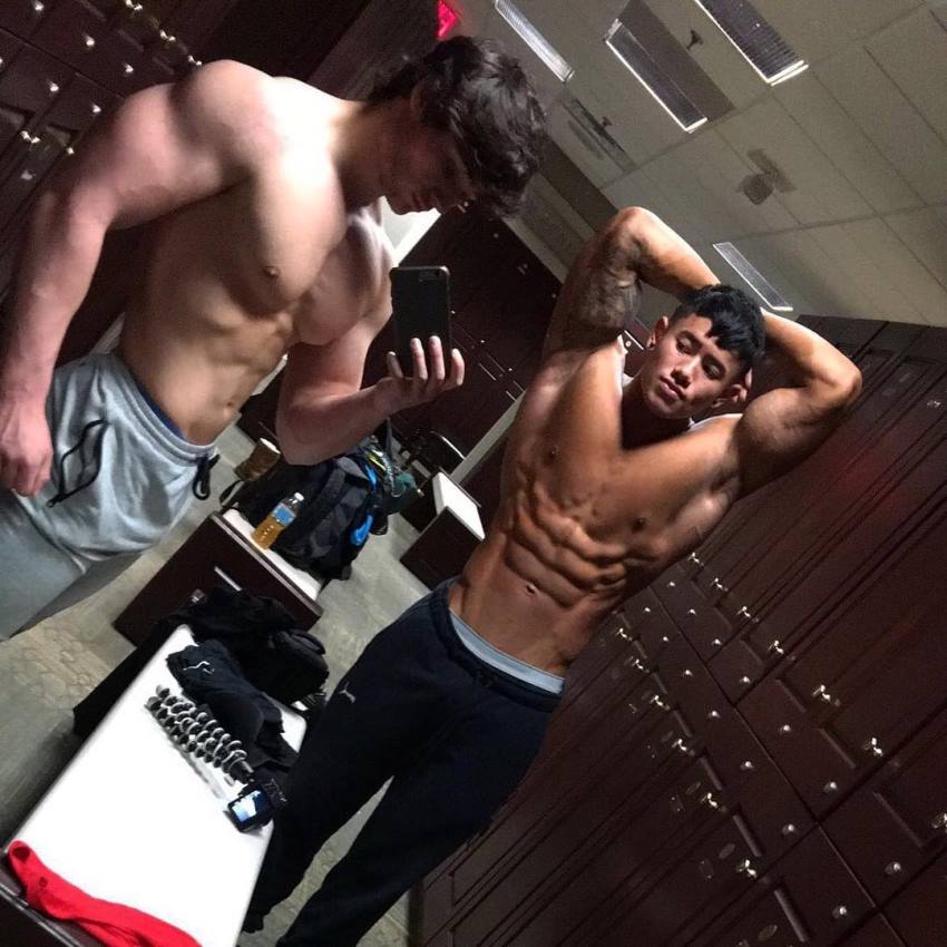 Dylan McKenna taking a selfie in gym locker room flexing with Steven Cao