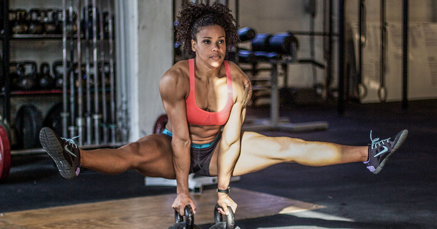 Elizabeth Akinwale performing exercises with kettlebells.