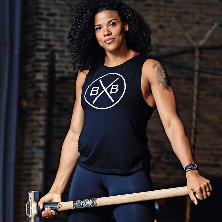 Elizabeth Akinwale holding a hammer in a photo shoot.