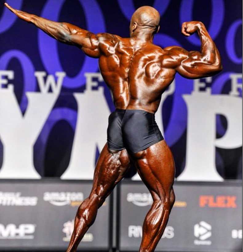 George Peterson flexing his back on the bodybuilding stage