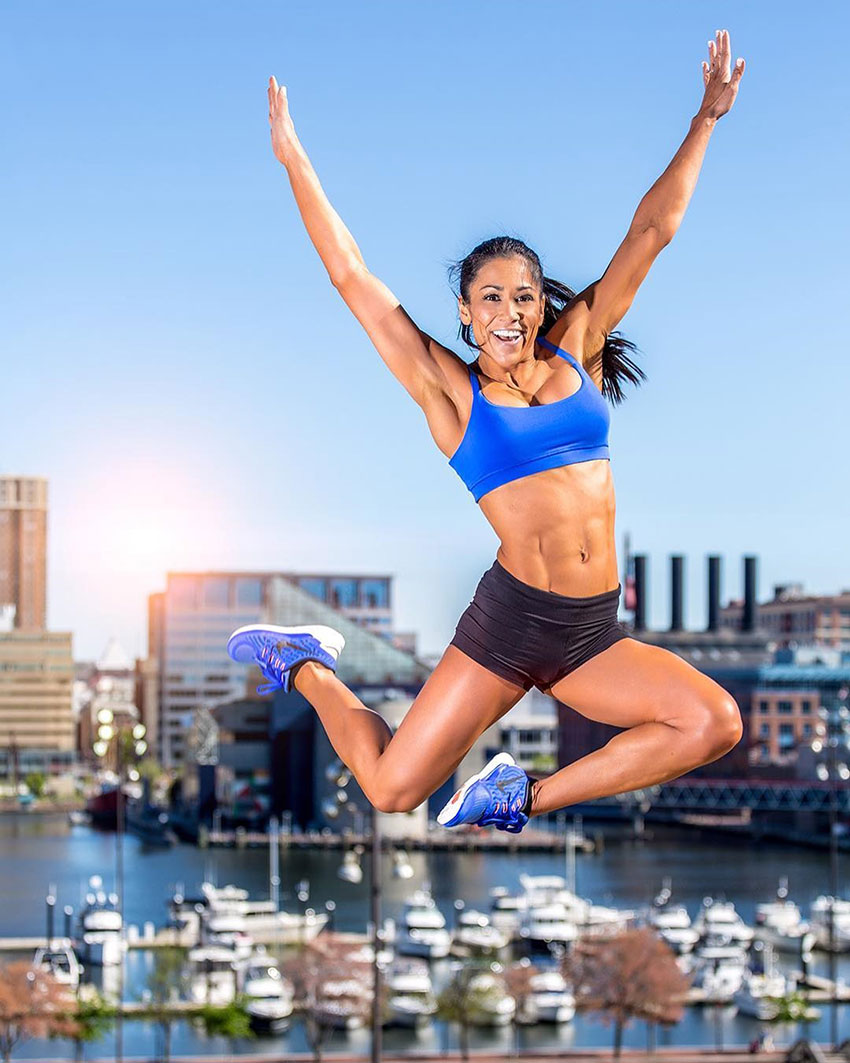 Jennifer Ronzitti jumping into the air in a photo shoot.