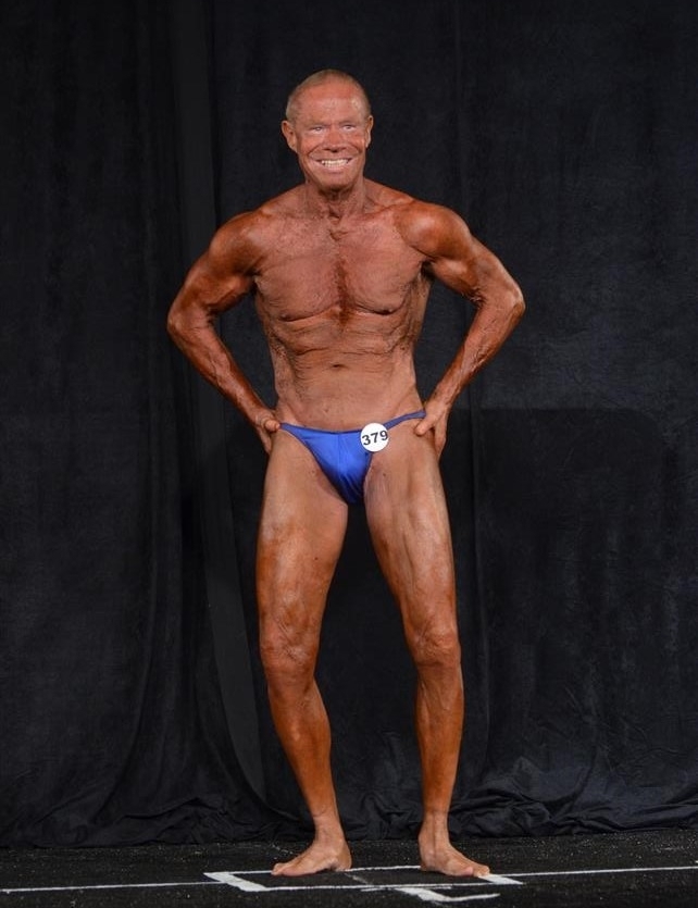 Jim Arrington flexing on the bodybuilding stage