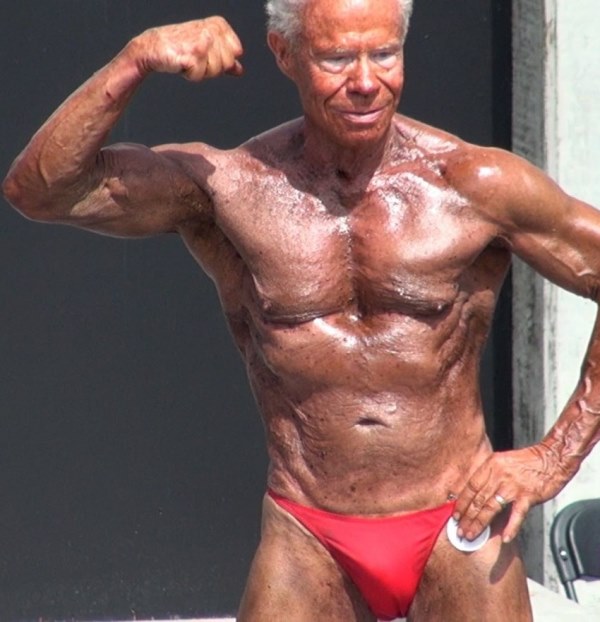 Jim Arrington flexing his biceps in an outdoor bodybuilding contest