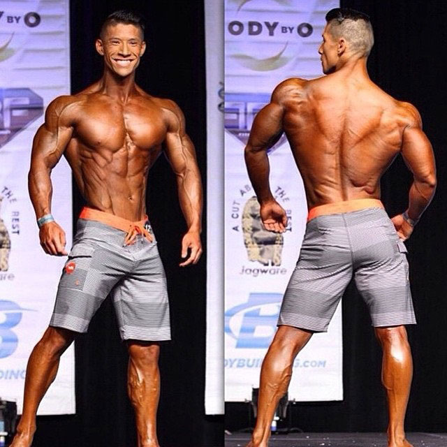 John Nguyen posing on the bodybuilding stage.