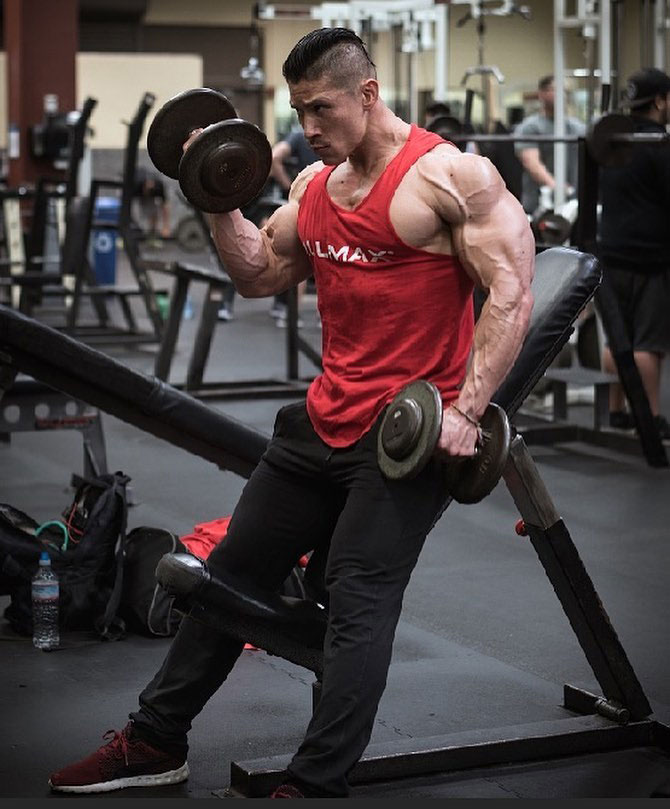 John Nguyen performing bicep curls.